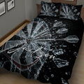 Close bedroom view of a black dartboard quilt blanket with shattered glass and flying darts