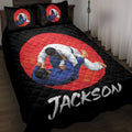Black jiu jitsu quilt blanket displayed on a bed with grappling artwork in a red circle