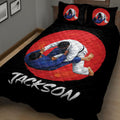 Close view of black jiu jitsu bedding with two grapplers and red circular artwork