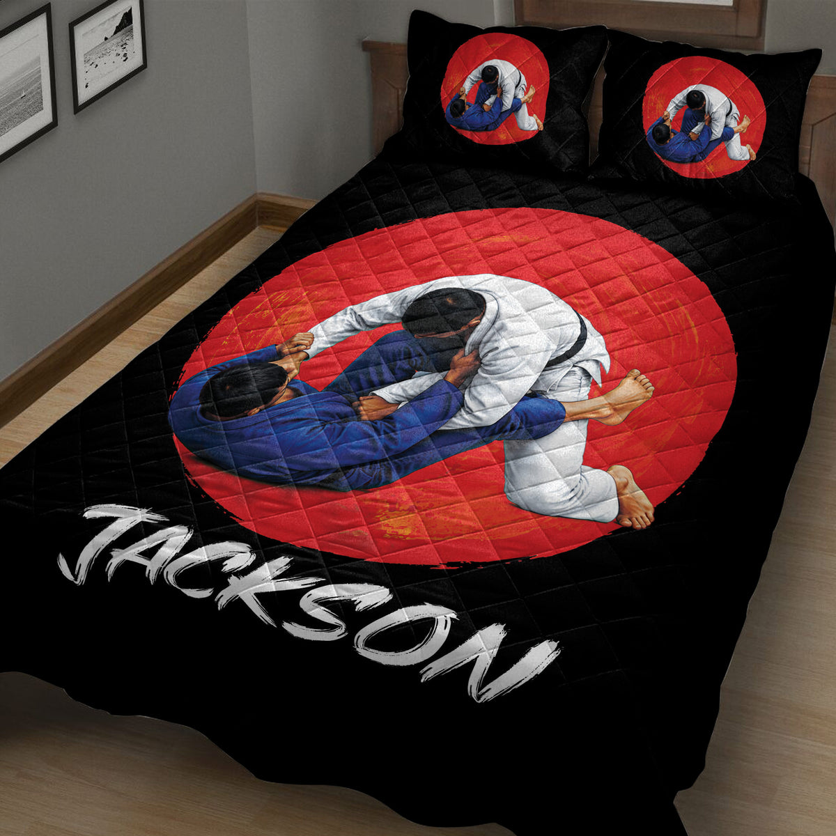 Close view of black jiu jitsu bedding with two grapplers and red circular artwork