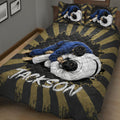 Close bedroom view of a jiu jitsu quilt blanket with two grapplers and bold black and gold rays