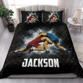 Wrestling quilt blanket styled on a modern bed with dramatic red and blue grappler artwork