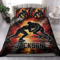 Wrestling quilt bedding styled in a bright bedroom with bold grappling artwork in red, black, and gold