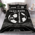 Black soccer quilt bedding set shown on a bedroom bed with white field lines and stadium illustrations