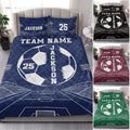 Navy soccer quilt blanket bedding set displayed on a bed with field artwork and multiple color options