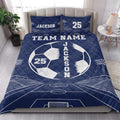 Navy soccer quilt bedding set styled across a bedroom with a large soccer ball and stadium field design