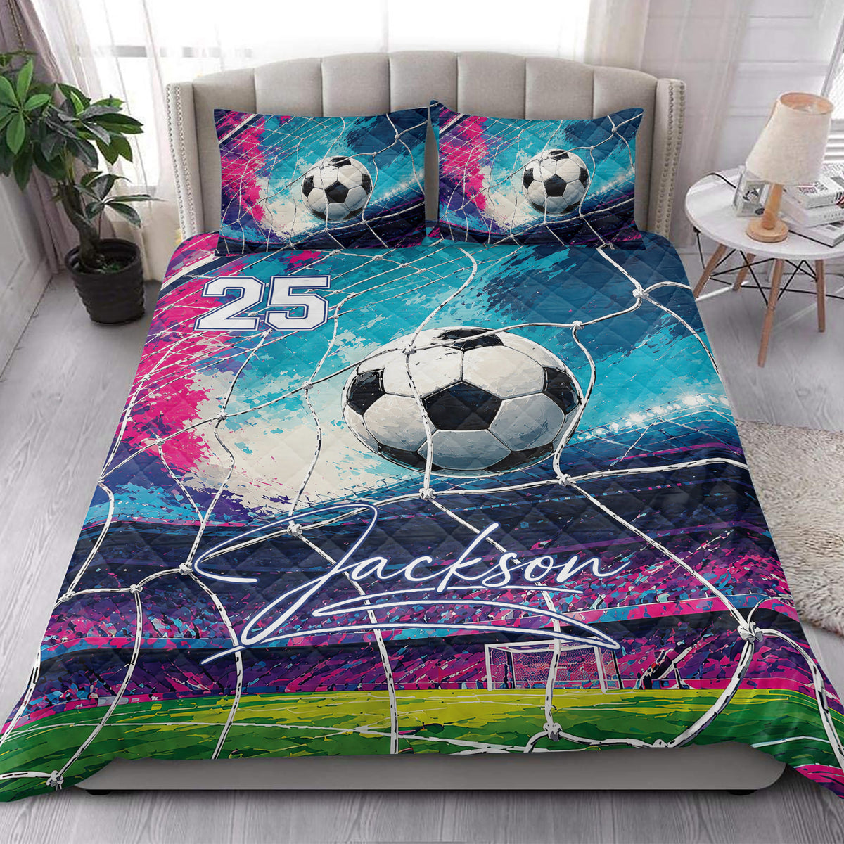 Soccer quilt bedding styled in a bright bedroom with ball, goal-net, and colorful field artwork