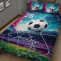 Close view of a soccer quilt blanket featuring a large soccer ball, net pattern, field, and vivid abstract colors