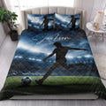 Soccer quilt blanket styled on a bedroom bed with stadium lights, field, and player artwork