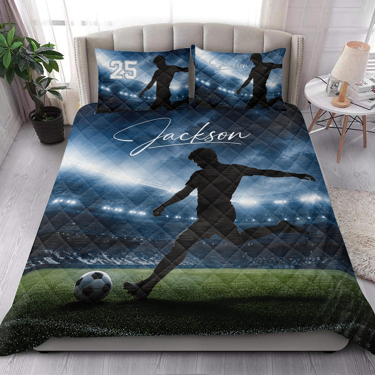 Soccer quilt blanket styled on a bedroom bed with stadium lights, field, and player artwork
