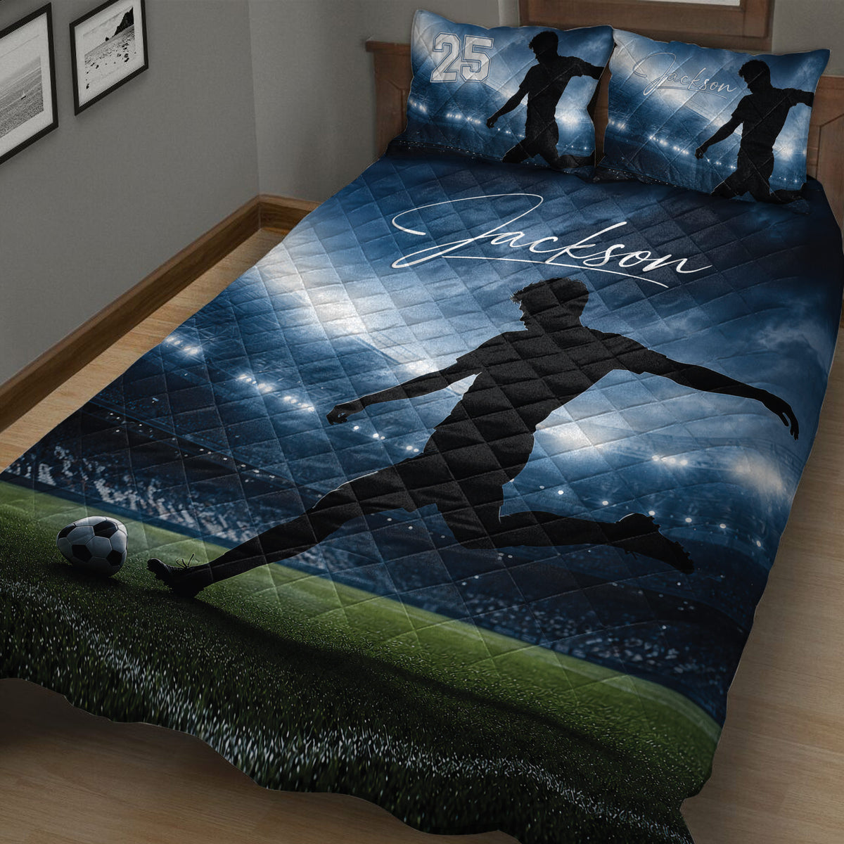 Close bedroom view of a blue soccer quilt with player silhouette, stadium, and field design