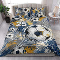 Soccer quilt blanket styled on a bedroom bed with oversized ball artwork and blue gold accents