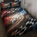 Racing quilt blanket displayed on a bed with checkered flags, track artwork, and bold red, black, white, and blue colors