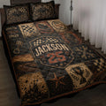 Dirt track racing quilt blanket displayed on a bed with checkered flags, racing helmet, tires and vintage motorsport artwork