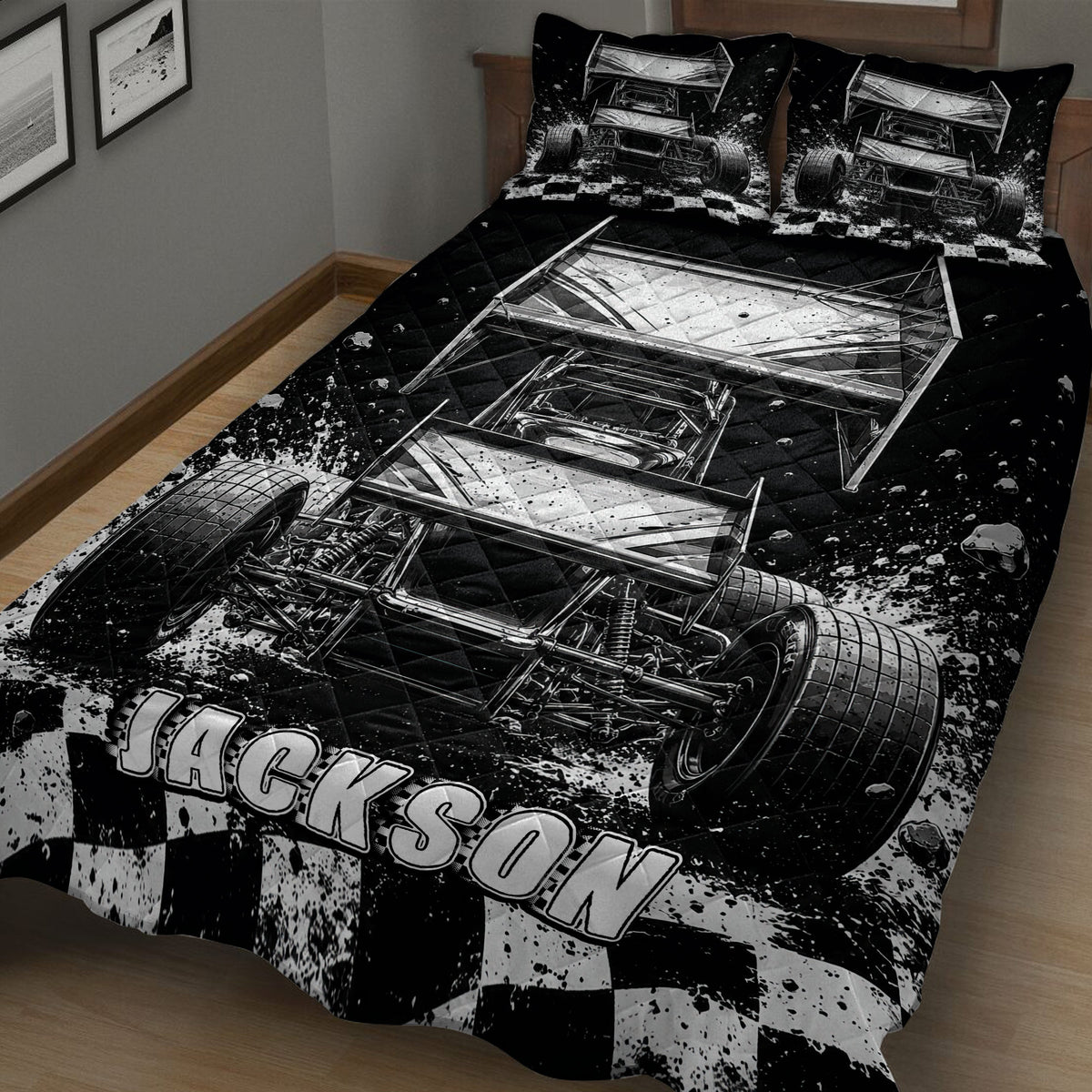 Close bedroom view of a black and white dirt track racing quilt with sprint cars and checkered graphics
