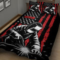 Close bedroom view of a black and red welder quilt with welding artwork and star details
