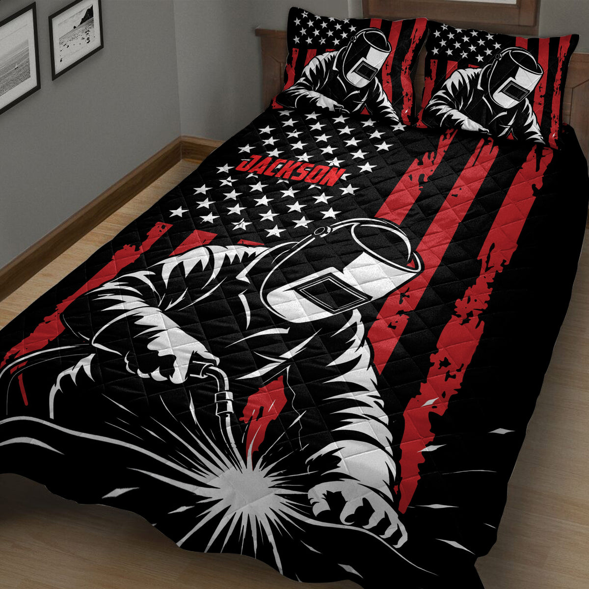 Close bedroom view of a black and red welder quilt with welding artwork and star details