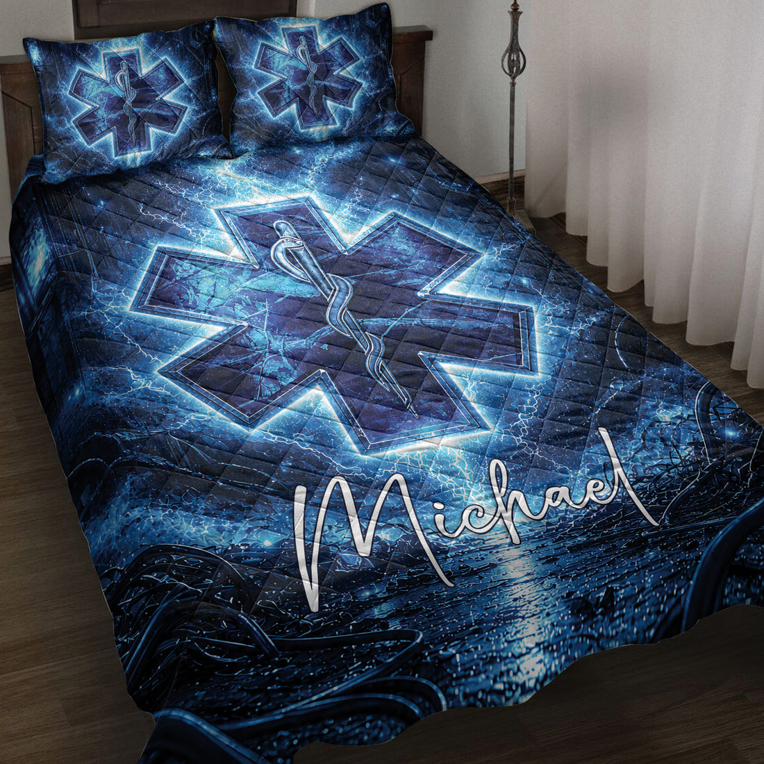 Blue paramedic quilt blanket displayed on a bed with glowing Star of Life and medical staff artwork