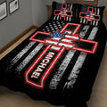 Angled bedroom view of a black paramedic quilt with distressed stripes and Star of Life design