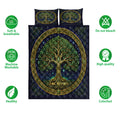 Tree Of Life quilt bedding set shown against a white background with a central leafy tree and dark blue artwork