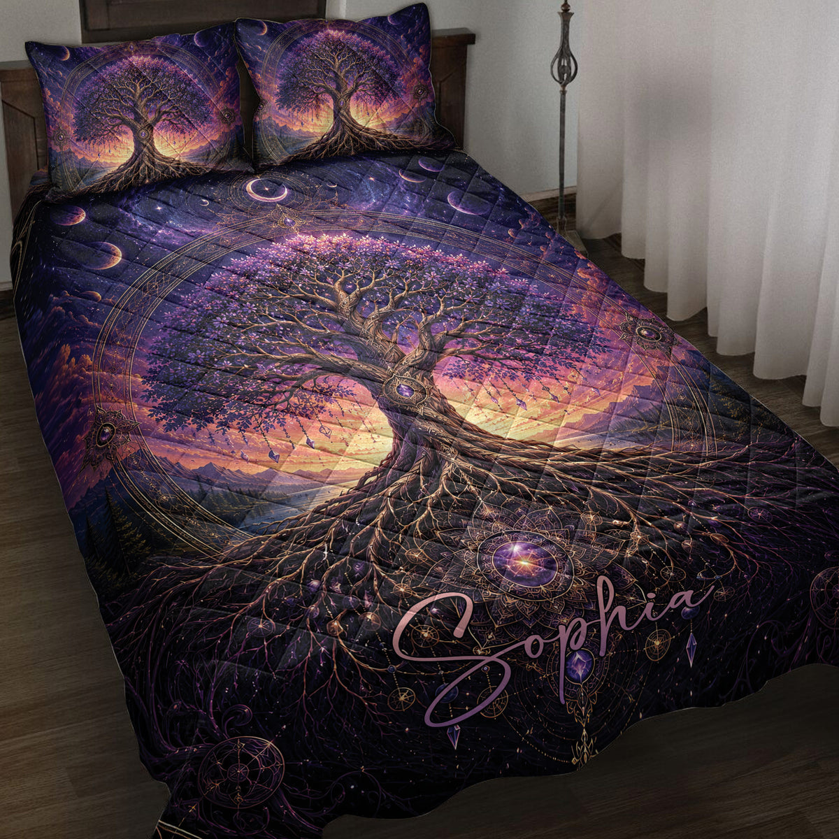 Tree Of Life quilt blanket displayed on a bed with cosmic moons and purple celestial artwork