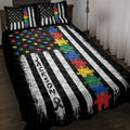 Autism quilt blanket displayed on a bed with colorful puzzle pieces, awareness ribbon, and black and white stripes