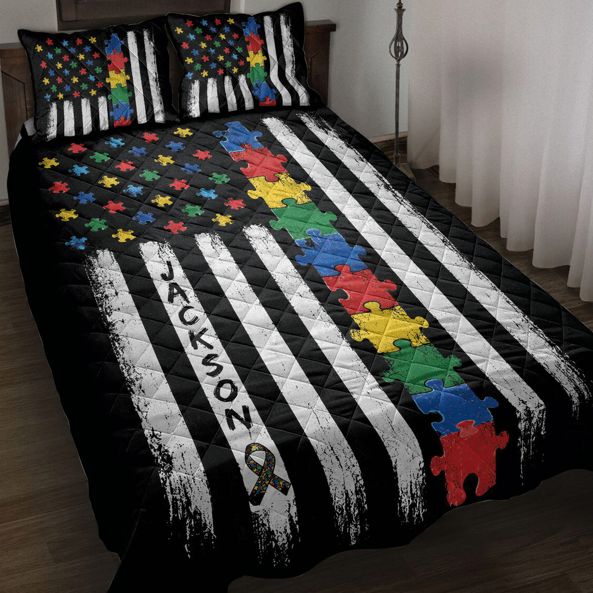 Autism quilt blanket displayed on a bed with colorful puzzle pieces, awareness ribbon, and black and white stripes
