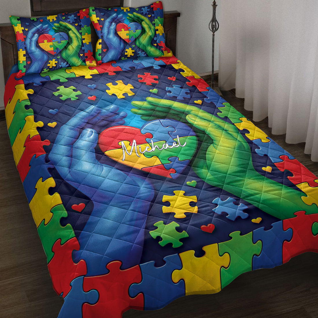 Colorful autism quilt blanket with puzzle pieces, heart motif, and supportive blue and green hands on a bed