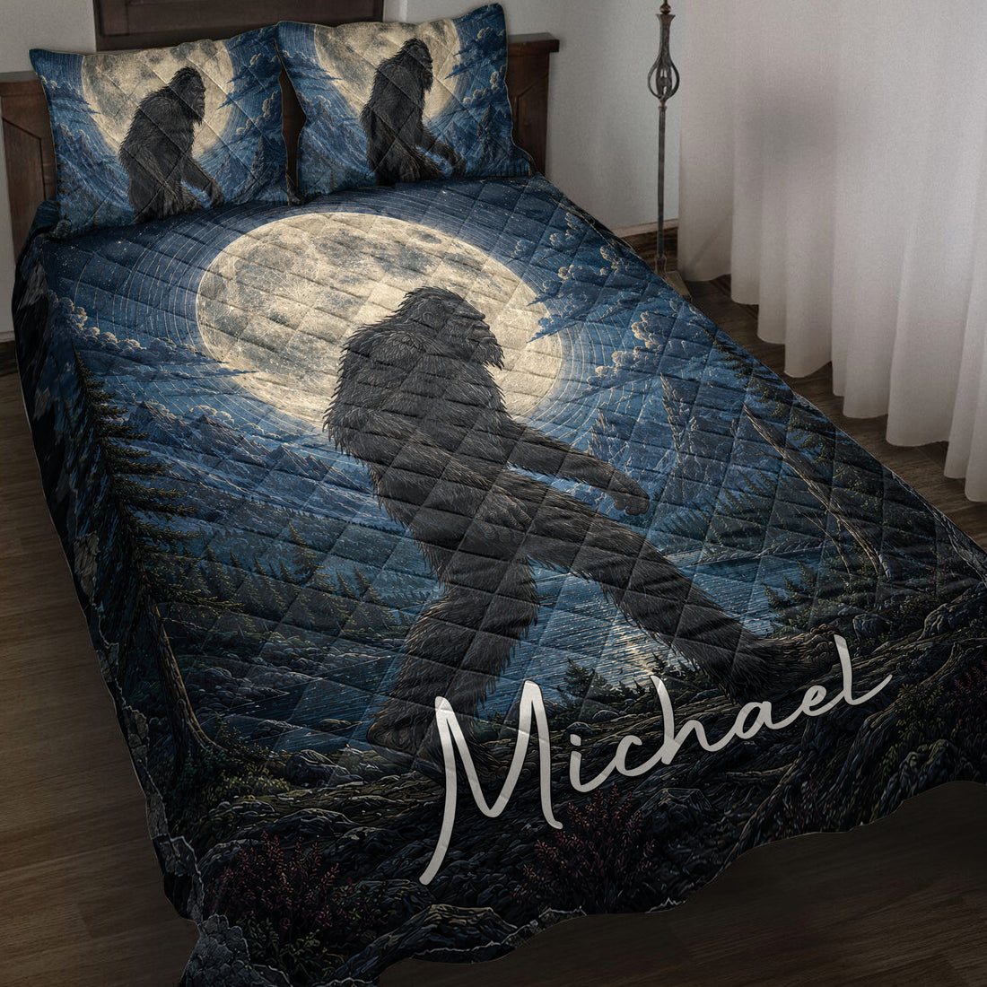 Bigfoot quilt blanket displayed on a bed with moonlit forest artwork in deep blue tones