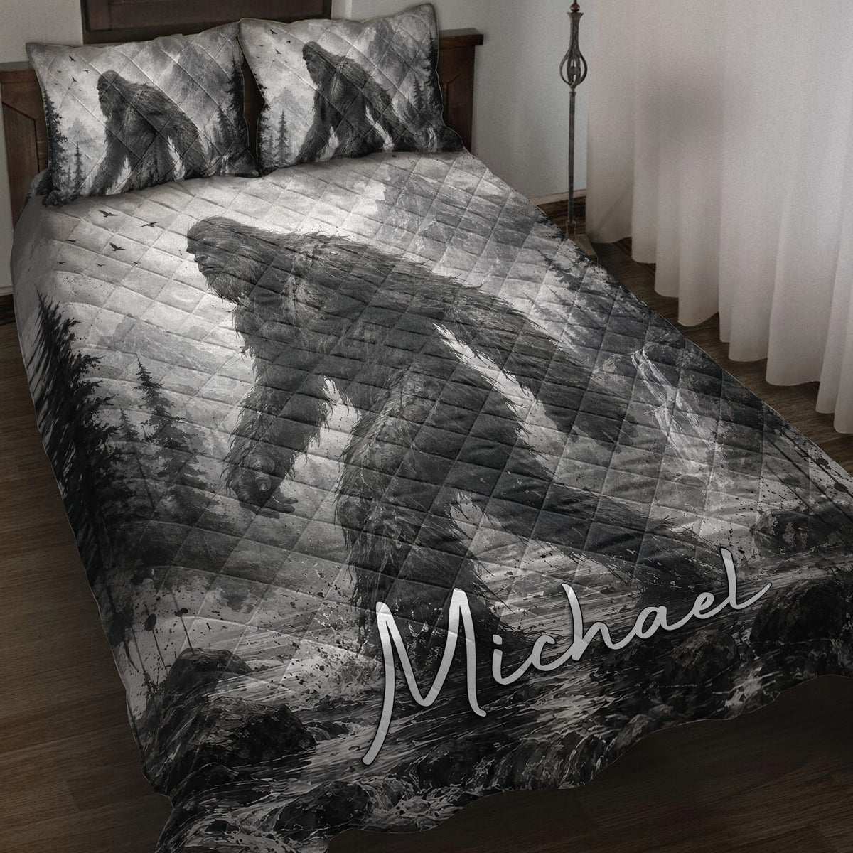 Bigfoot quilt blanket displayed on a bed with grayscale mountain, forest, waterfall, and Sasquatch artwork