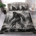 Bigfoot quilt blanket styled in a bright bedroom with Sasquatch, mountain, and forest artwork