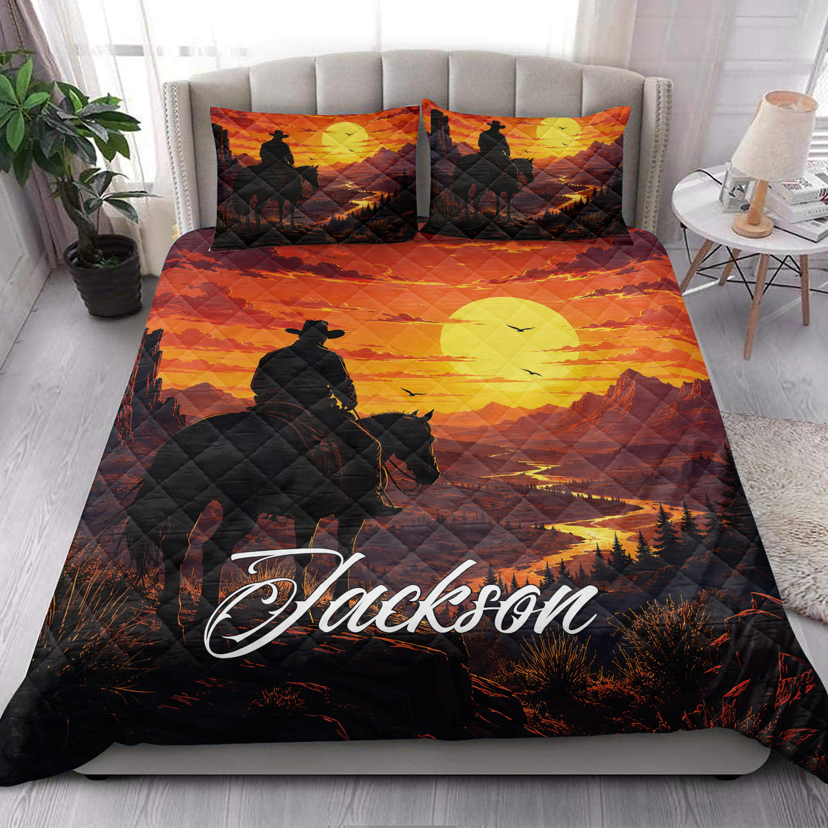 Cowboy quilt bedding styled in a bedroom with a horseback rider, mountain sunset, and western landscape design