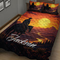 Western cowboy quilt blanket spread across a bed with horse rider silhouettes, desert mountains, and sunset colors