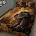 Close view of a cowboy quilt blanket featuring Western boots, a cowboy hat, rope, and warm wood tones