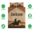 Western cowboy quilt bedding set shown with horseback rider artwork, mountain scenery, and warm sunset colors