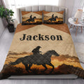 Cowboy quilt bedding styled in a bright bedroom with horseback rider artwork and sunset mountain scenery