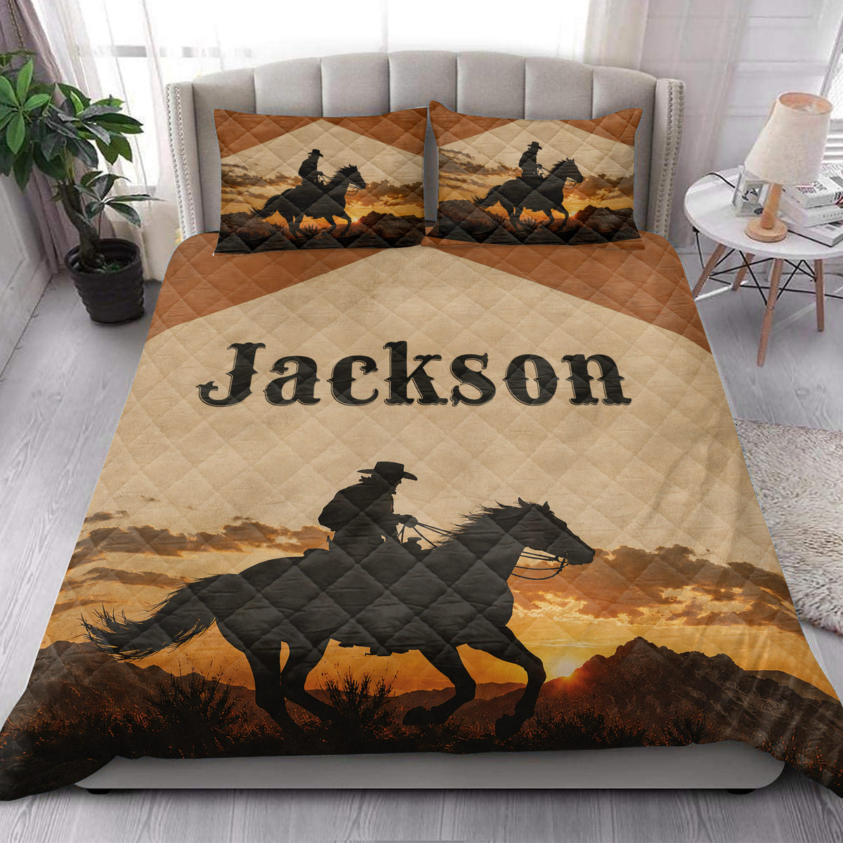 Cowboy quilt bedding styled in a bright bedroom with horseback rider artwork and sunset mountain scenery