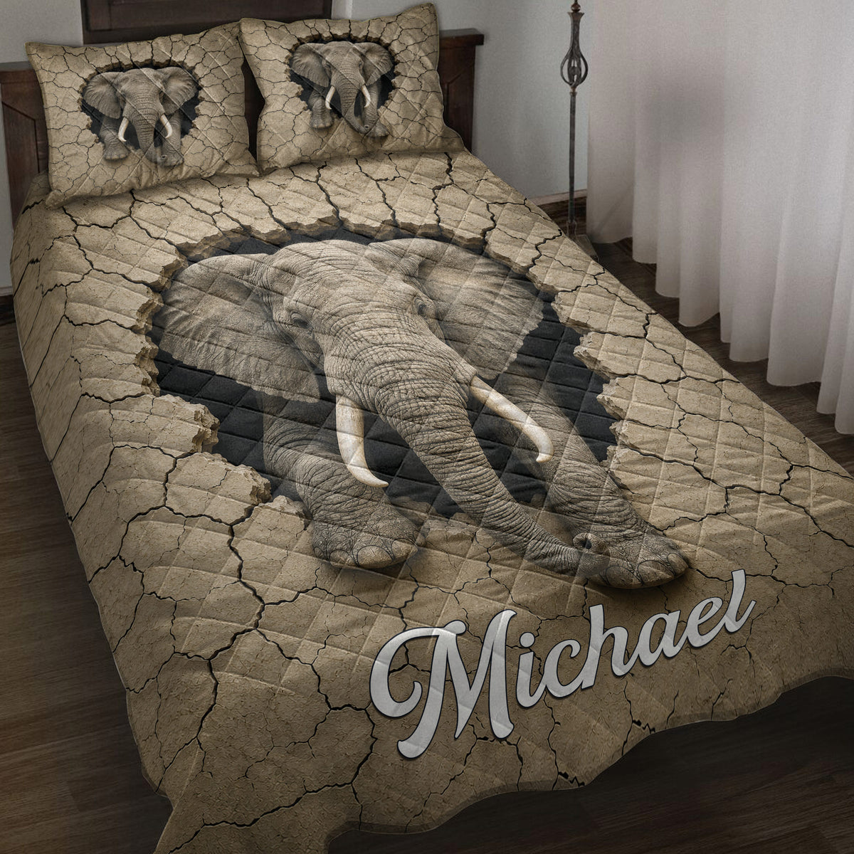 Elephant quilt blanket displayed on a bed with dramatic cracked-earth artwork and elephant imagery