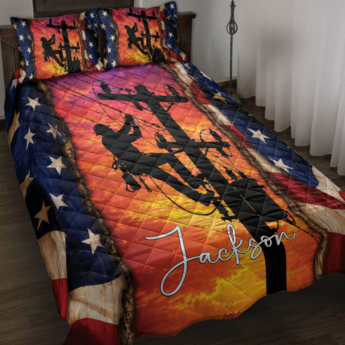 Lineman quilt blanket displayed on a bed with utility worker silhouettes, power lines, and patriotic star accents