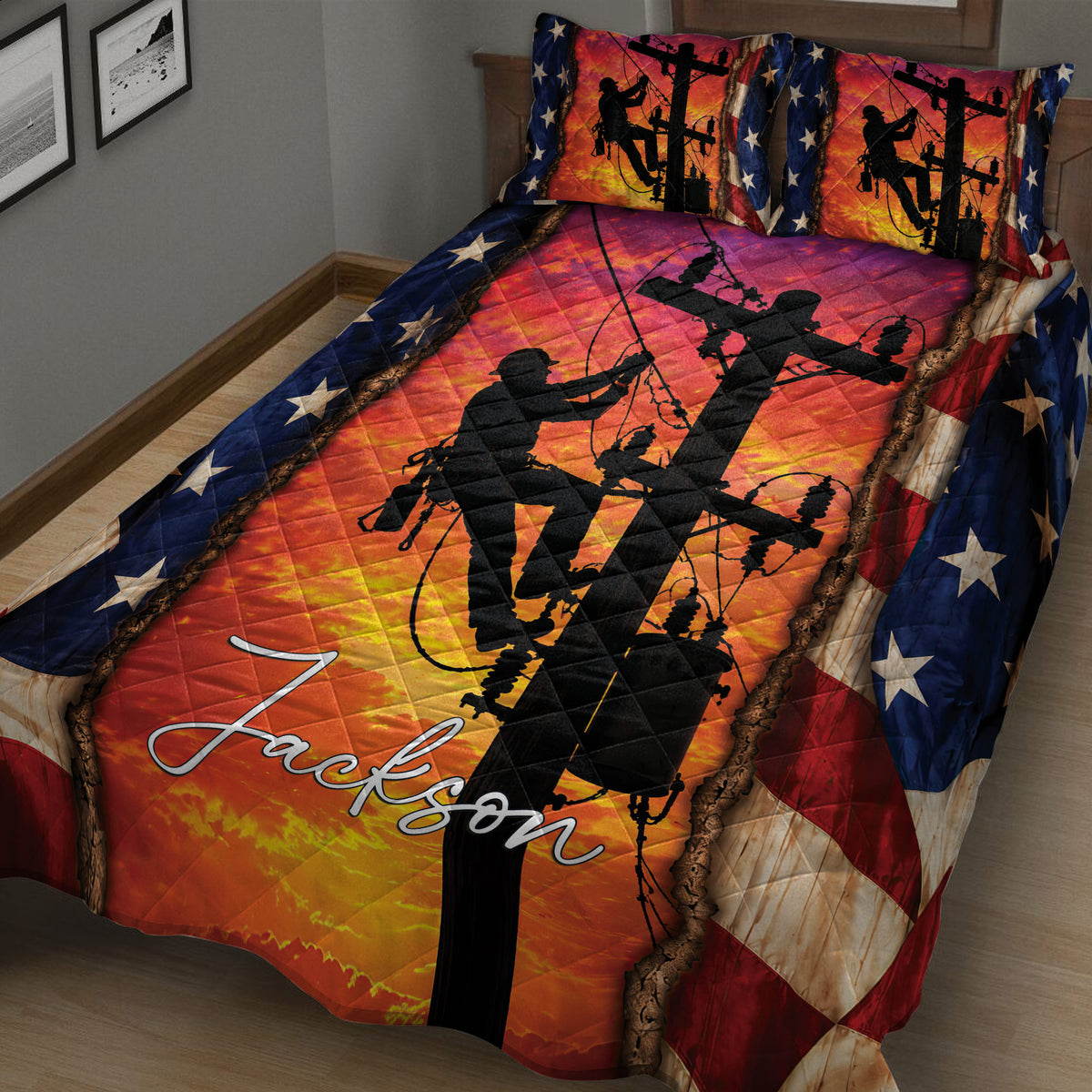 Lineman quilt blanket displayed across a bed with power pole silhouettes, vivid orange artwork, and star accents