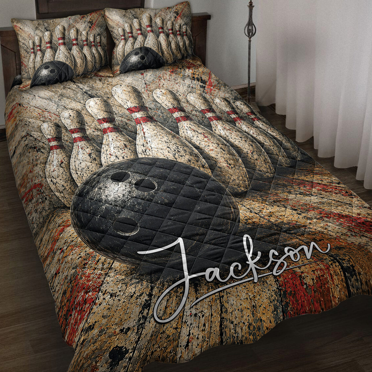 Bowling quilt blanket displayed on a bed with black bowling balls, pins, and vivid red accents