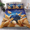 Bowling quilt blanket styled in a bright bedroom with blue ball and pin artwork