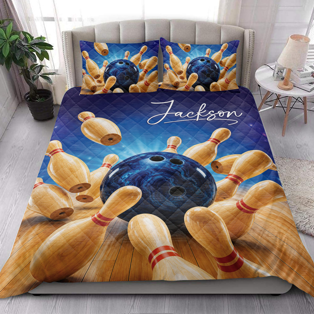 Bowling quilt blanket styled in a bright bedroom with blue ball and pin artwork