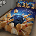 Close bedroom view of a bowling quilt blanket with vivid blue and wood-toned artwork