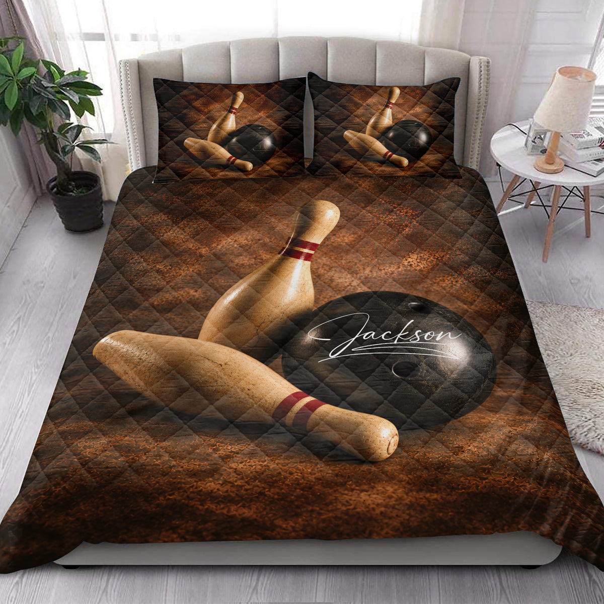Bowling quilt bedding styled in a bright bedroom with pins and bowling balls across the bed