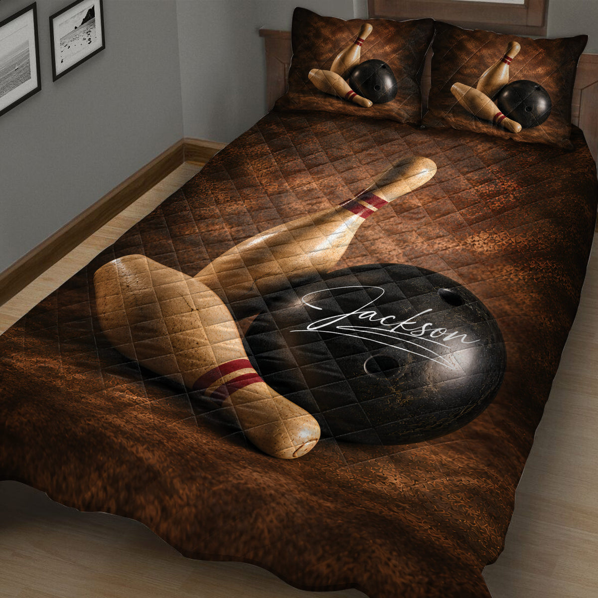Close bedroom view of a bowling quilt blanket featuring oversized pins and black bowling balls
