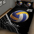 Close-up of a black volleyball quilt blanket with large blue and gold ball and net artwork
