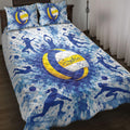 Blue and yellow volleyball quilt blanket displayed on a bed with player silhouettes and watercolor splashes