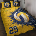 Volleyball quilt blanket in navy, gold, and white with net artwork styled on a bedroom bed