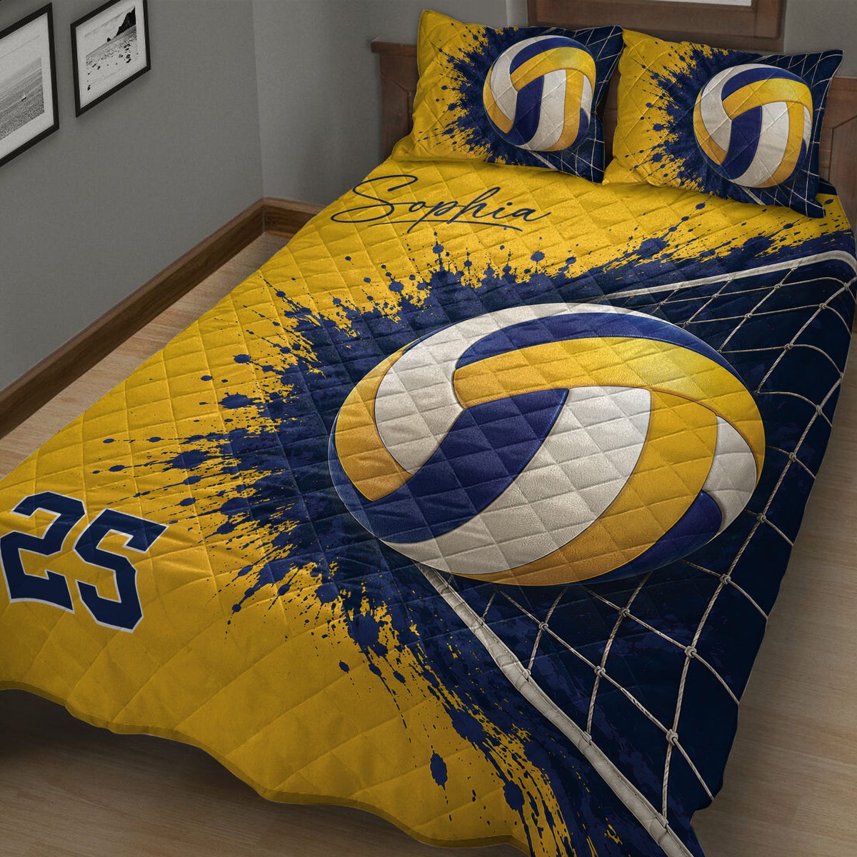 Close bedroom view of a navy and gold volleyball quilt blanket with ball and net graphics